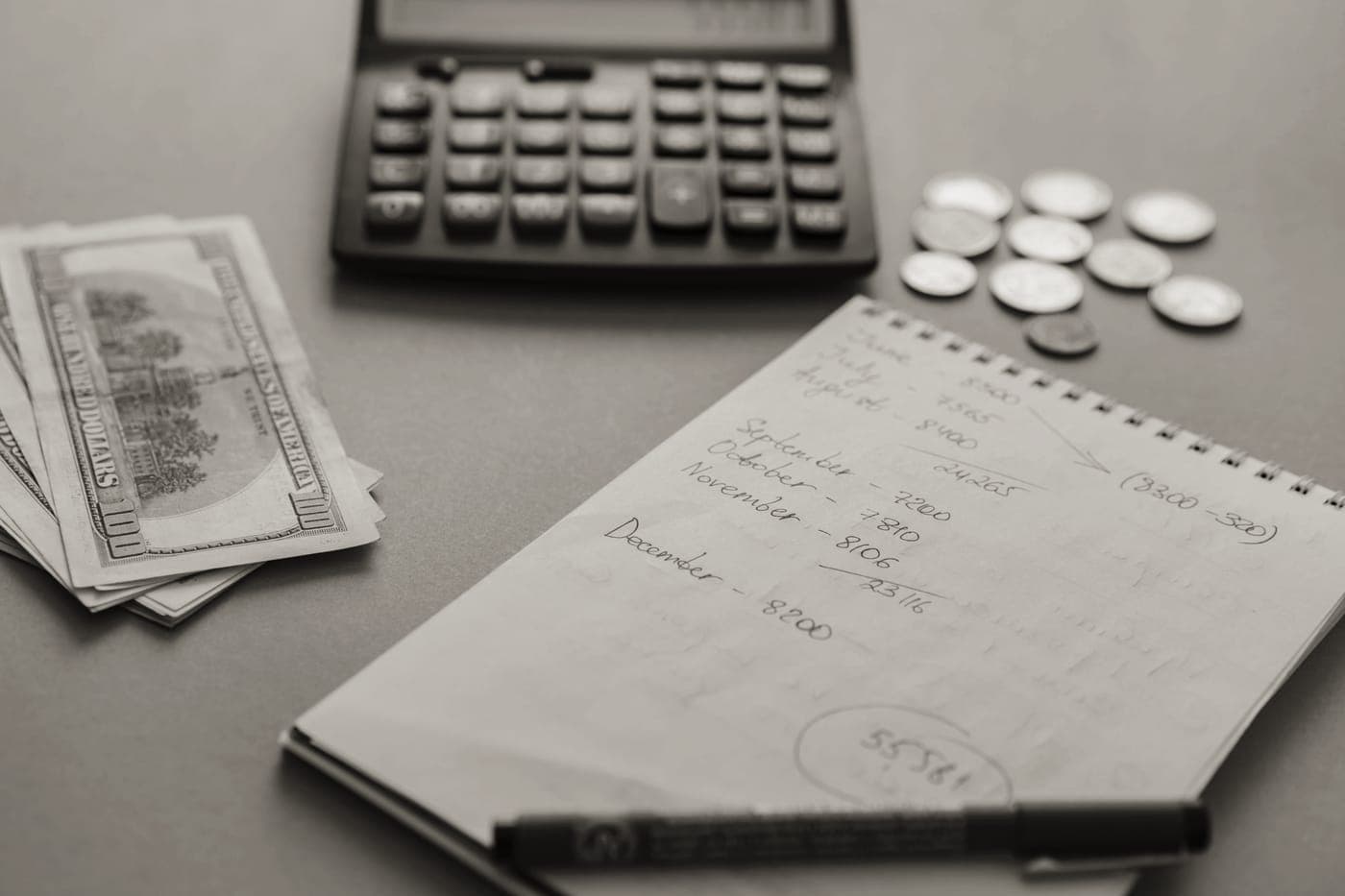 A notebook beside cookware on a kitchen counter